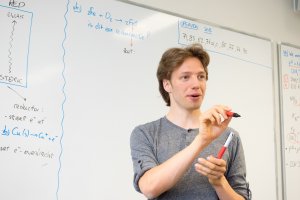 Een docent geeft klassikale uitleg bij SSL, de Leidse Examentraining