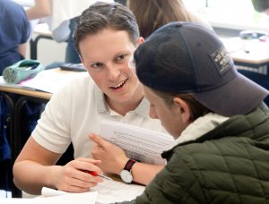 Een docent die een leerling helpt bij SSL, De Leidse Examentraining