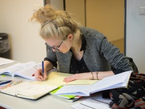 Docent kijkt na tijdens een examentraining geschiedenis van SSL Leiden.